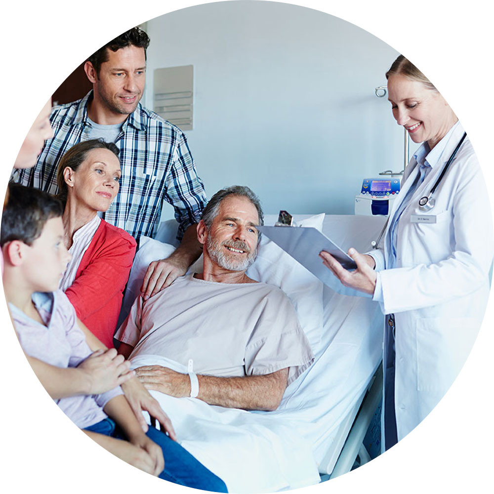 man in hospital bed with family, speaking to doctor