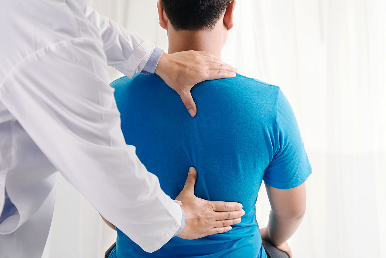 doctor's hands on patient's back